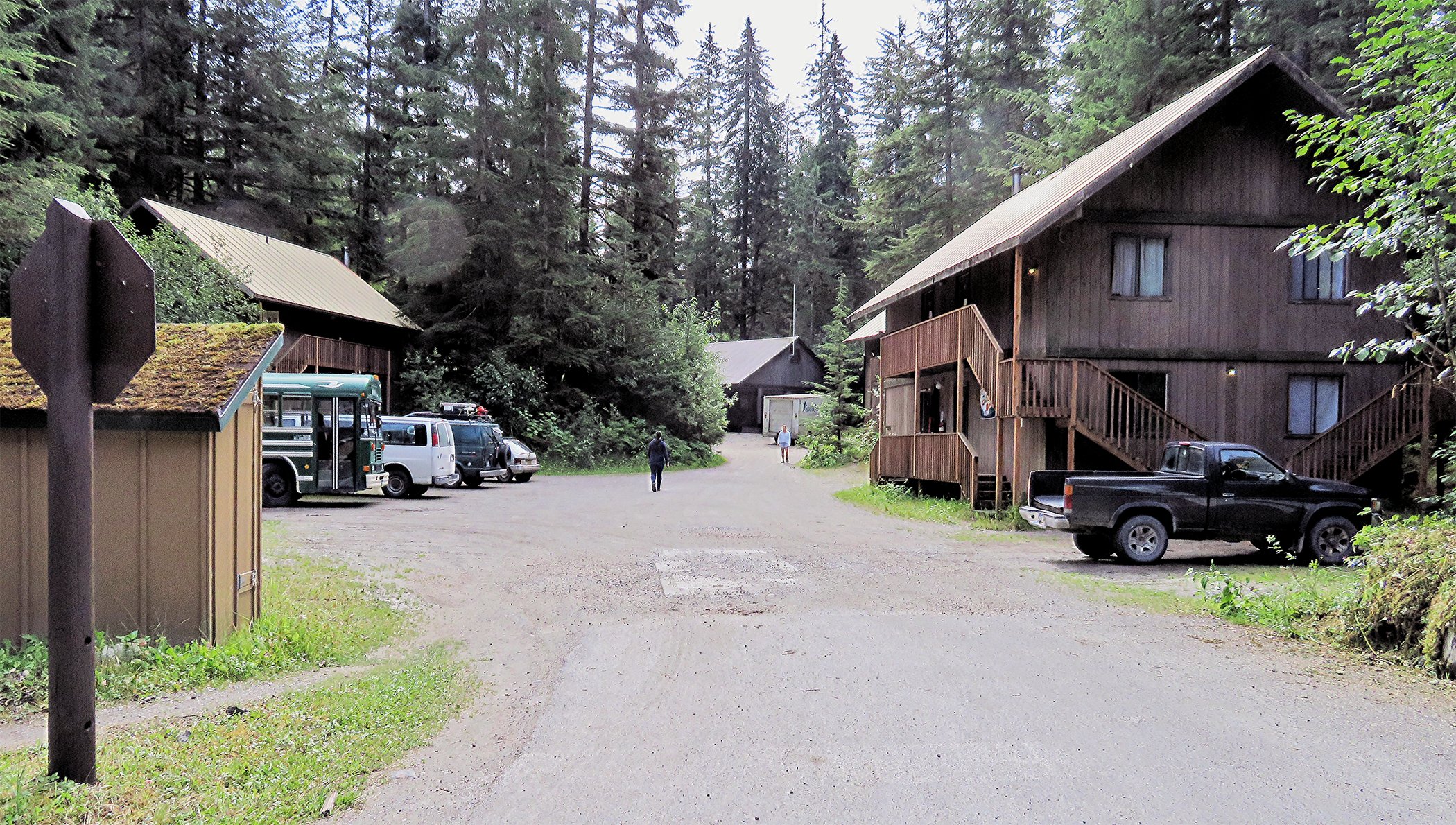 Dormitory housing and parking lot in forest setting.