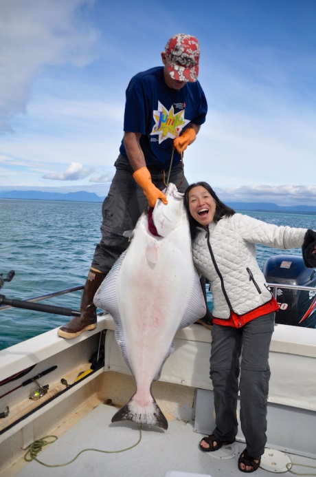 two anglers posing with a large halibut