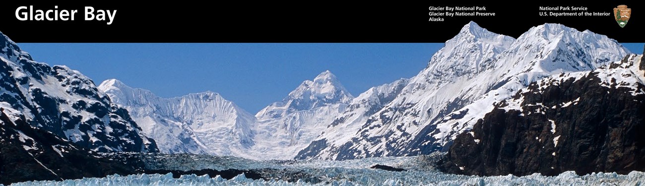 A glacier leads high into steep rocky snow-topped mountains. Graphic layout for Glacier bay at top