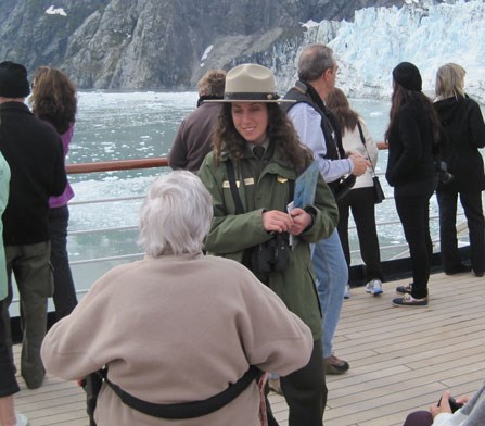 Passenger in wheelchair enjoying Glacier Bay with a park ranger Passenger in wheelchair enjoying Glacier Bay with a park ranger