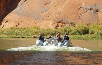 Following in the wake of large motorized raft full of people