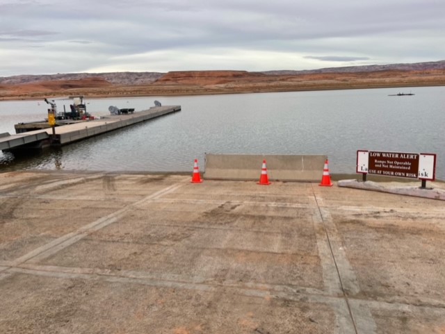 GLCA - Bullfrog North Ramp, Dec. 27, 2022. NPS Photo Concrete launch ramp leading to row of orange cones and sign: "Low Water alert"