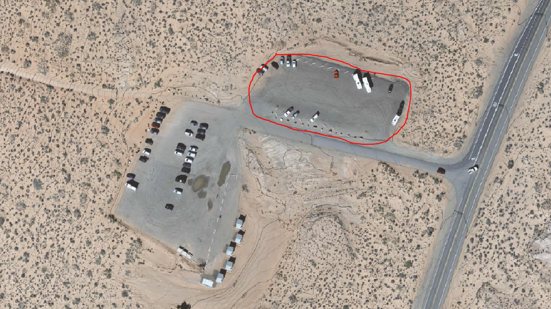 Aerial view of two parking lots with with upper right one circled in red