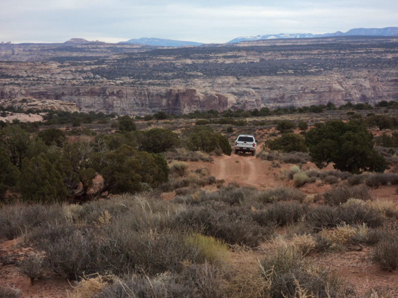 ORV use in scenic Glen Canyon National Recreation Area White vehicle on dirt road in wilderness