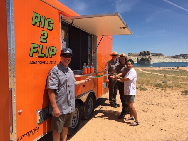 Food truck with three people in front of it