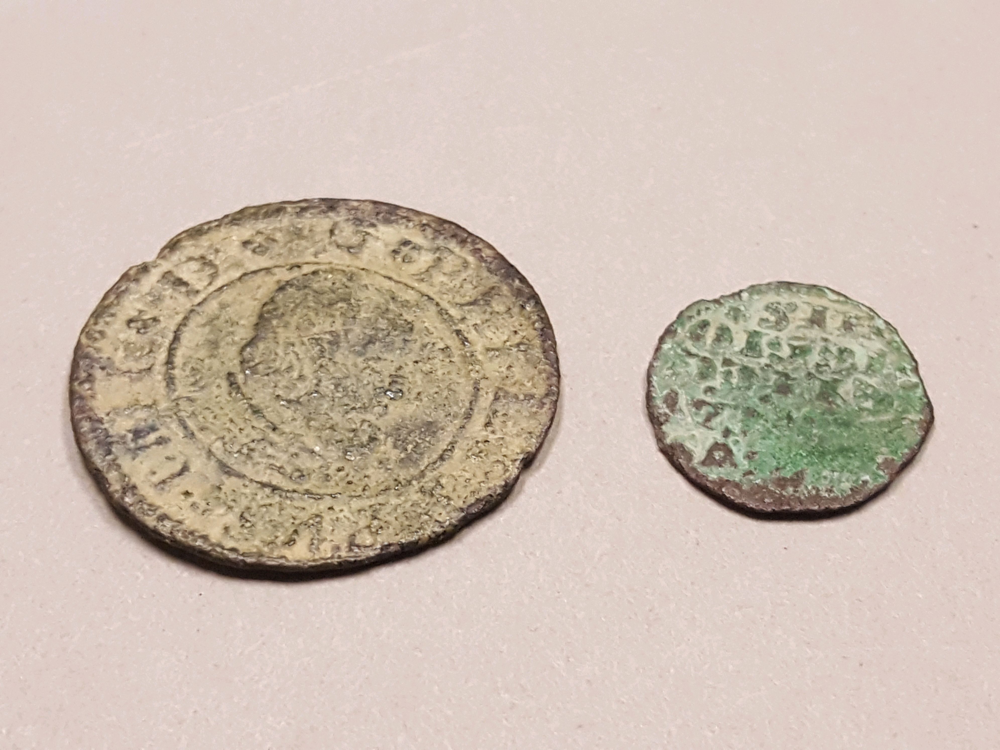 Two ancient looking coins of different sizes