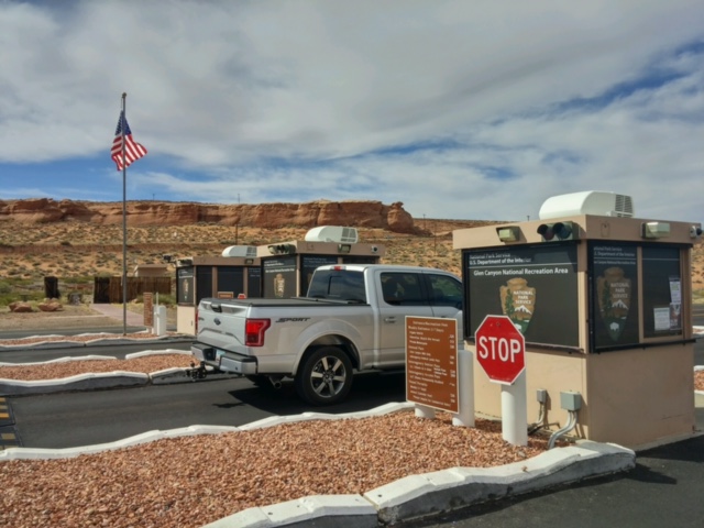 A pickup truck stopped at small building on road