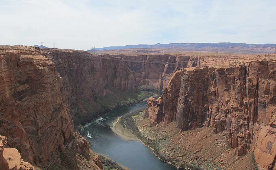 River curves in a deep high walled sandstone canyon.