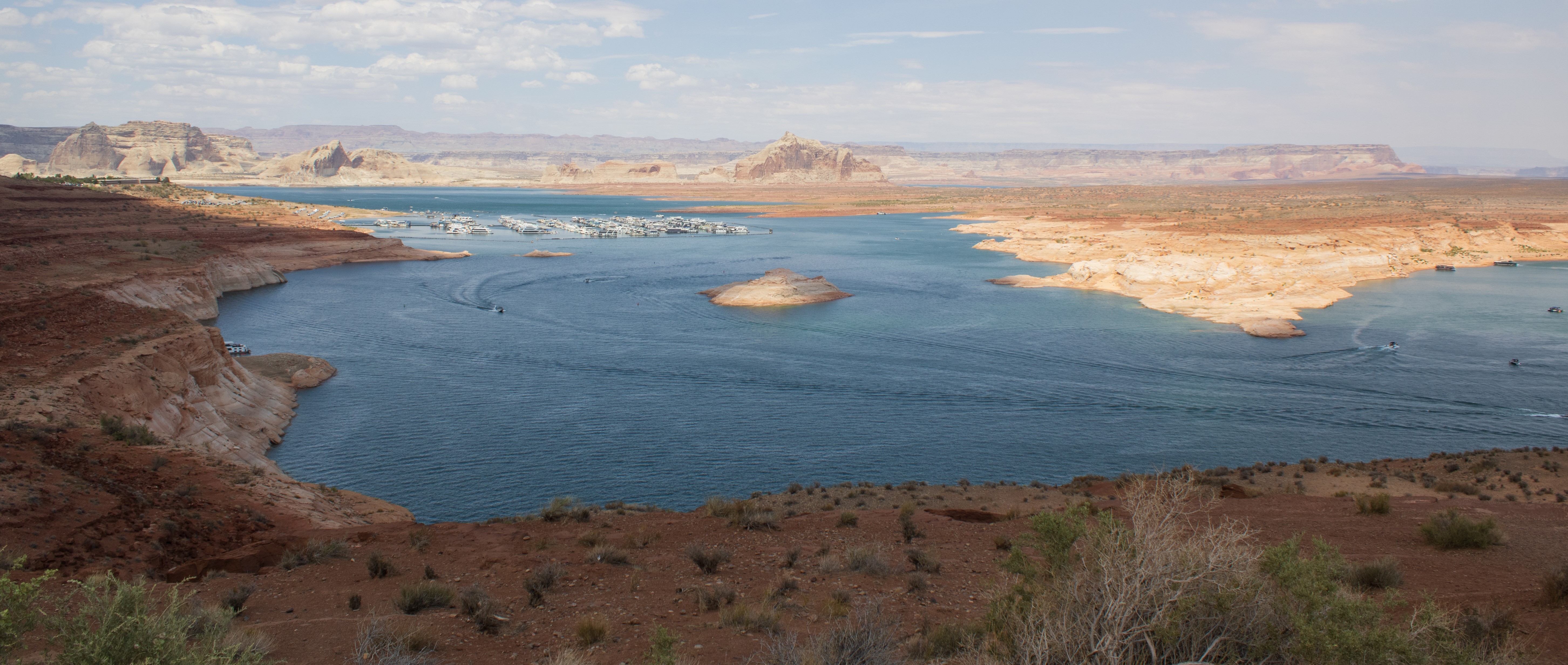 Desert lake in a sandstone canyon. Houseboat marina in background.