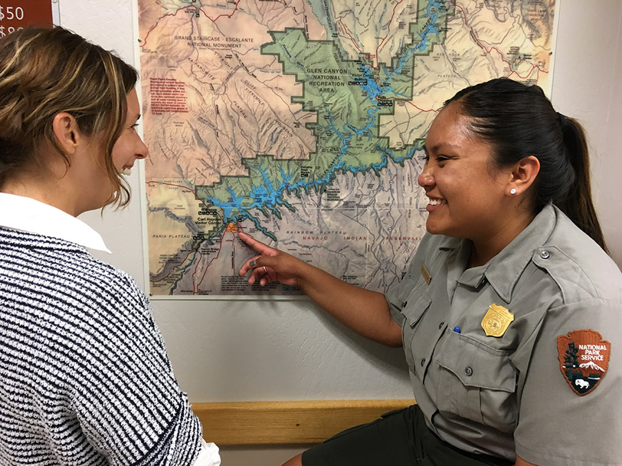 park ranger points at map with visitor