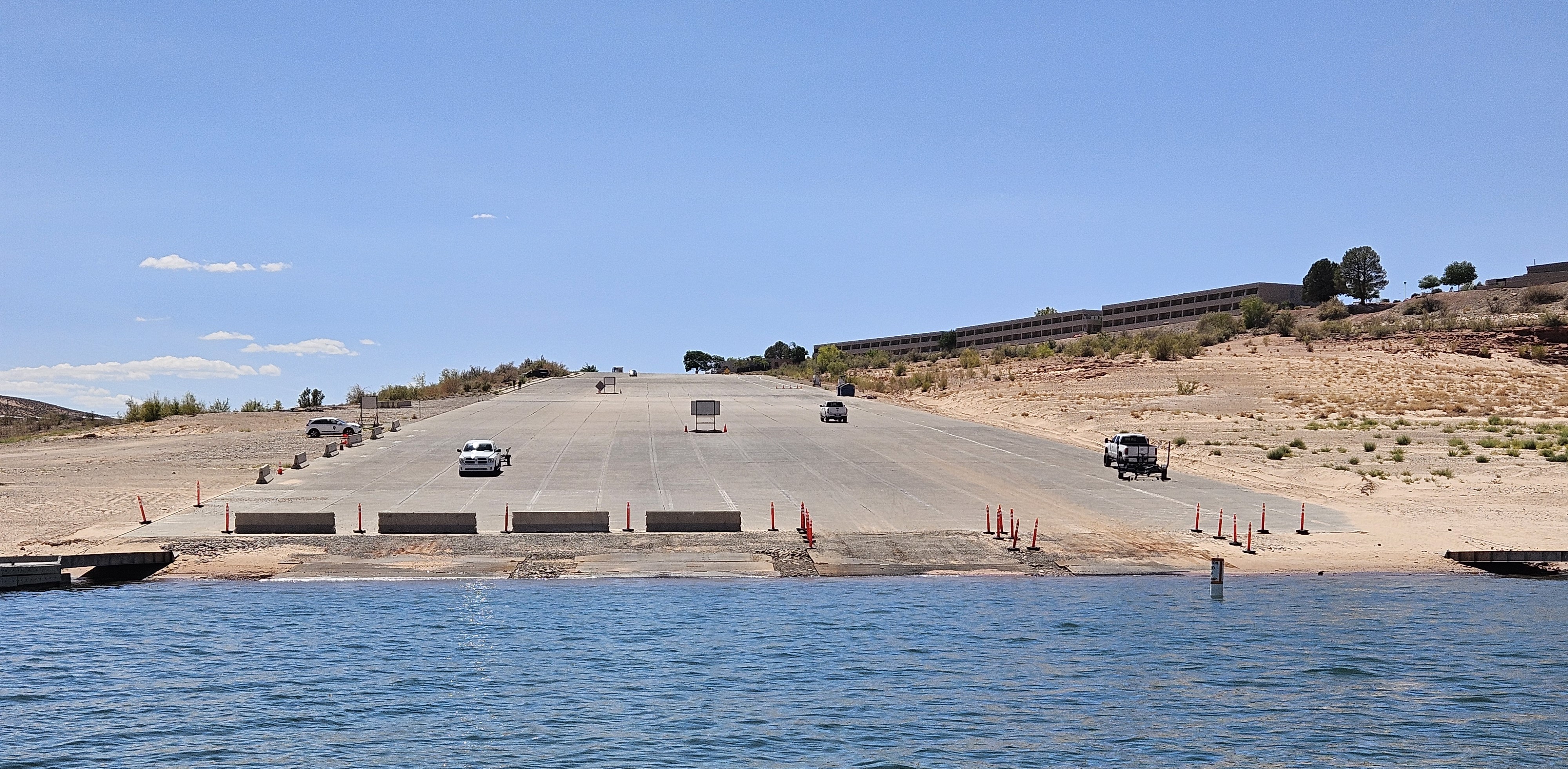 The end of a concete launch ramp with steel plates extending the ramp into the water.