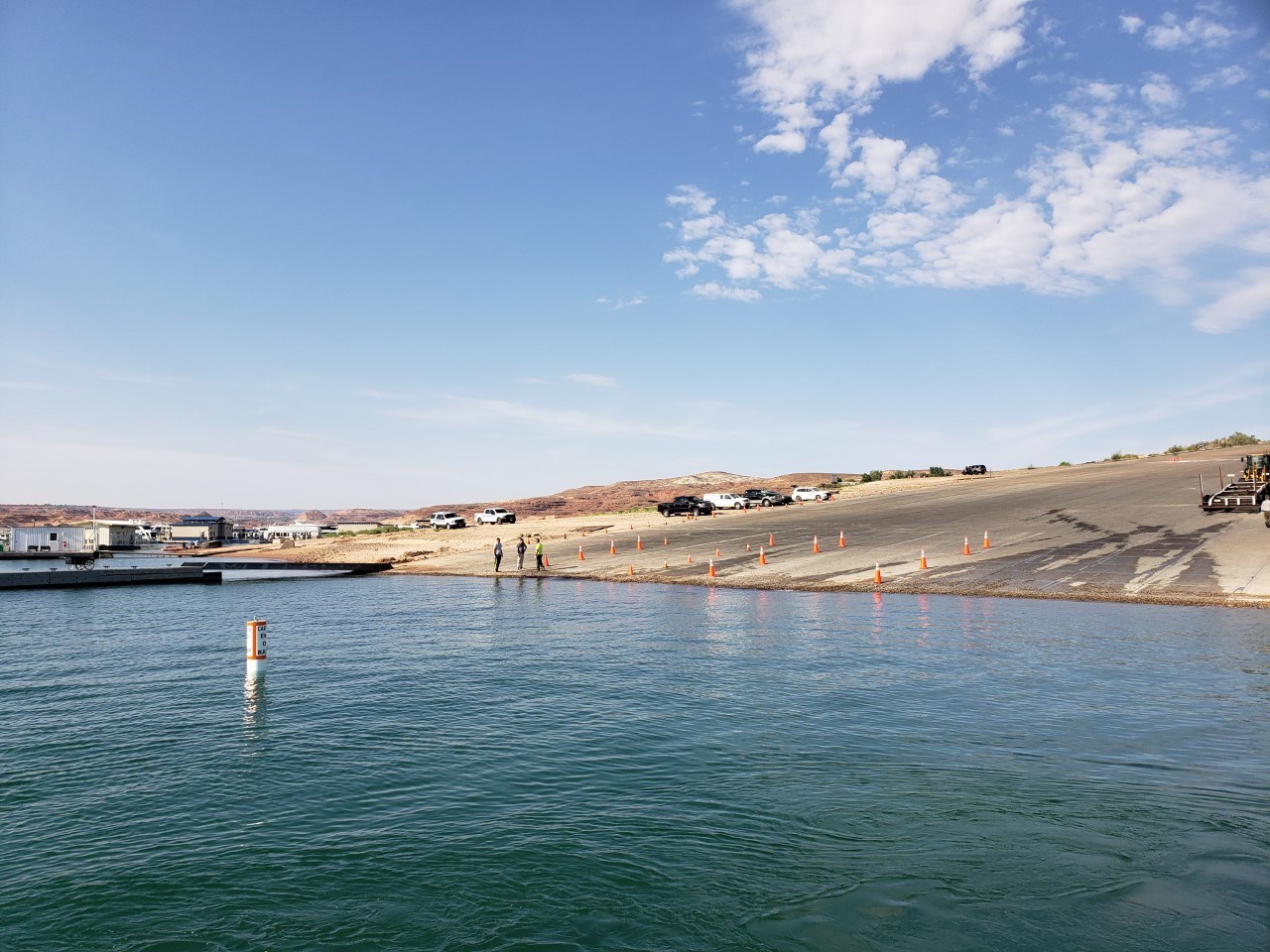 Concrete launch ramp ends at water. Hazard buoy.