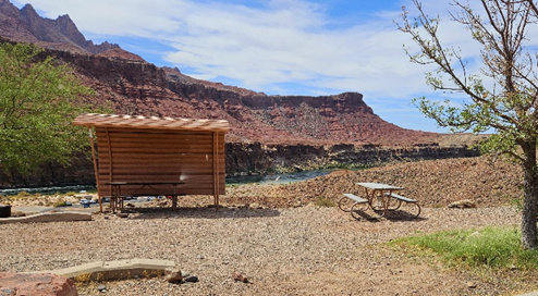 Lees Ferry Campground proposed fee increase Picnic tables adorn a desert campsite