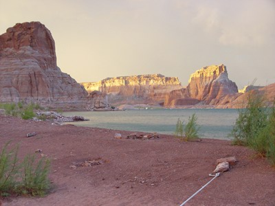 Beach with a rope held down by a large rock