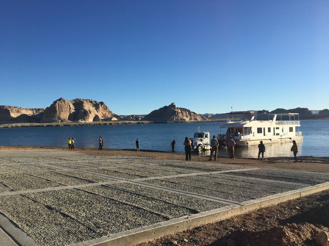 Park staff observe a houseboat retrieval on launch ramp