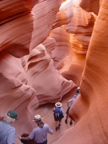 Group of rangers explores slot canyon