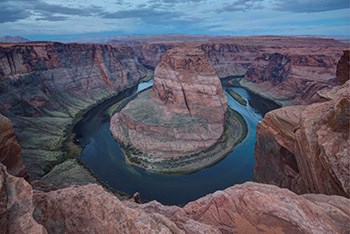 river flowing in a circular curve in sandstone canyon