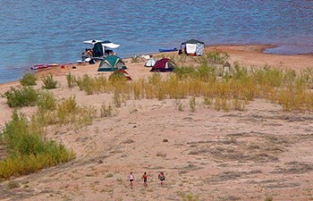 A cluster of tents at waters edge