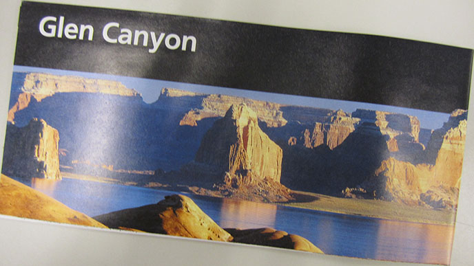 Image of Glen Canyon National Recreation Area's official brochure, with a black bar across the top and a picture of cliffs surrounding water. Image of Glen Canyon National Recreation Area's official brochure, with a black bar across the top and a picture of cliffs surrounding water.
