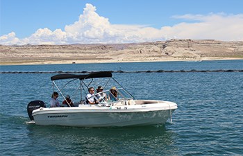 Family in boat idles out of marina