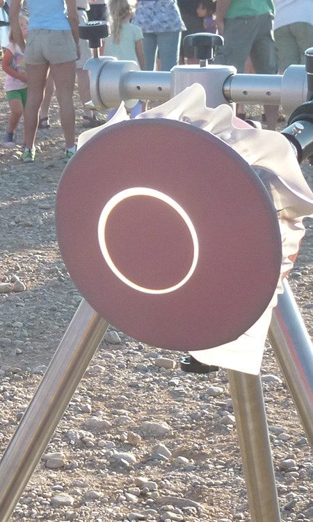 Solar scope with viewing pad on a tripod. Image of eclipsed sun is projected on the pad.