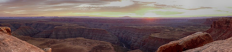 Panoramic view of canyons, rive, and mountain at sunset