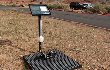 Sign and brush attached to metal grate