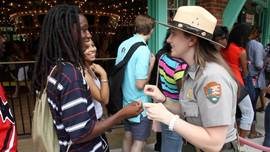 Ranger with visitors near carousel