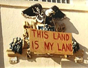 Photo of Indian Occupation era "This Land is My Land" sign hanging above the Alcatraz prison entrance