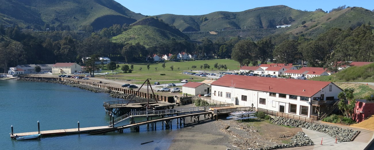 Fort Baker water front with buildings, large lawn and headlands in the background