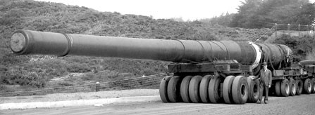 historic photo of large metal gun barrel on tractor wheels historic photo of large metal gun barrel on tractor wheels