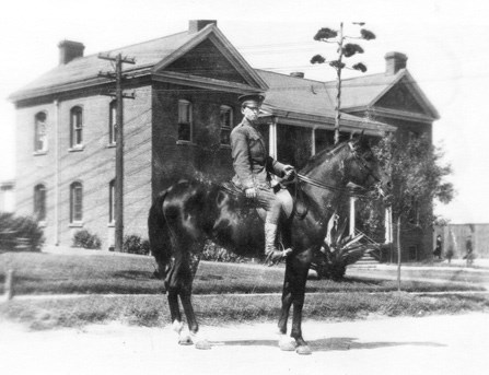 view of mounted soldier in front of historic brick building