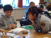 Intern Anh Nguyen working with a student during a Rocks on the Move presite. Intern Anh Nguyen working with a student during a Rocks on the Move presite.