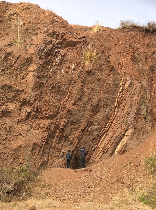 Chert outcrop with two park volunteers