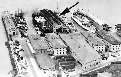 historic aerial of SF Port of Embarkation; large buildings in crowded pier area