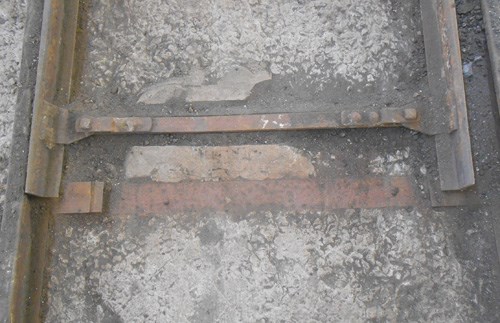 close-up detail of steel tracks inbedded in concrete