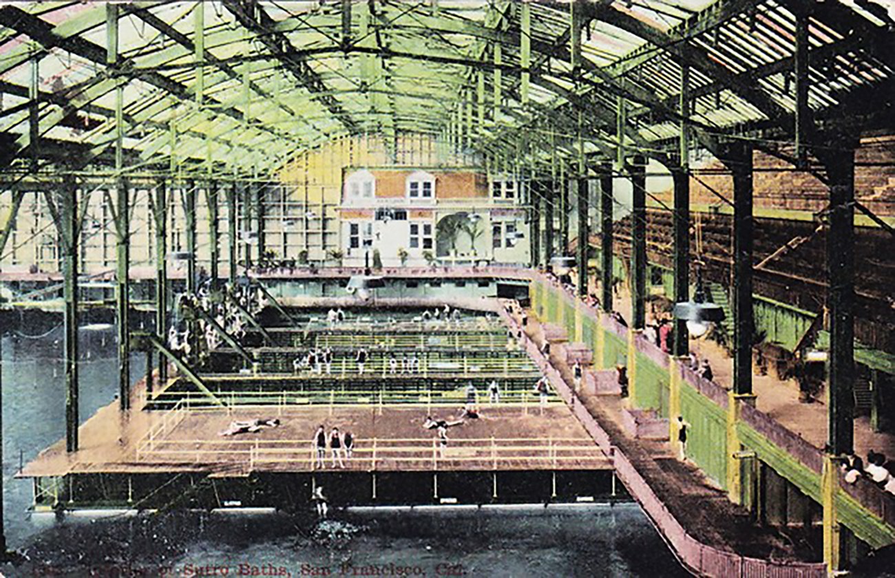 Historic colored postcard showing interior of ornate public bathhouse.