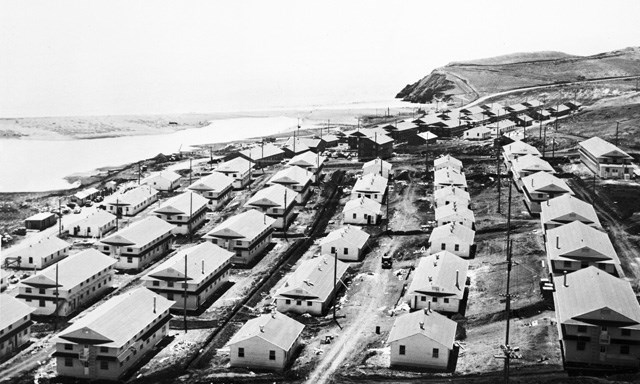 rows of wooden army barracks near beach rows of wooden army barracks near beach