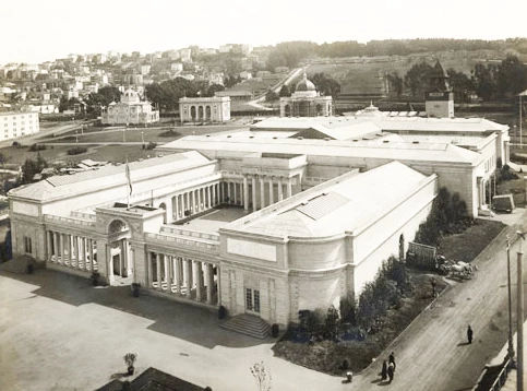 wide, formal building with rows of columns and open interior courtyard