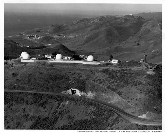 Overhead view of Hawk Hill, capped with radar domes and other equipment