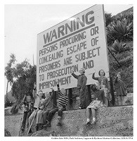 Alcatraz kids Waving in front of Warning sign