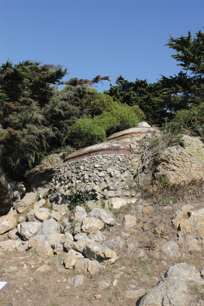 Large rock outcropping with military batteries at the top.