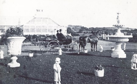 historic image of visitors in horse-drawn carriage in Sutro Heights garden