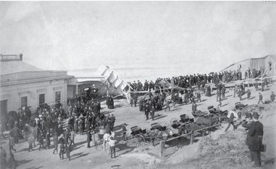 A group of people gathered to view the aftermath of a ship explosion. A group of people gathered to view the aftermath of a ship explosion.
