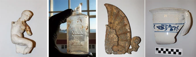 photo of small sculpture, glass bottle, roof detail and pottery