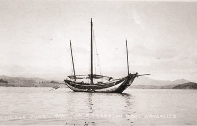 A traditional Chinese fishing vessel floating on the open ocean.