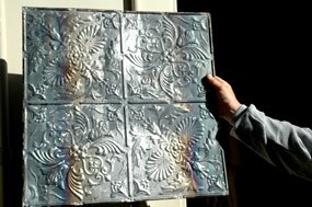 a newly-cleaned metal ceiling panel