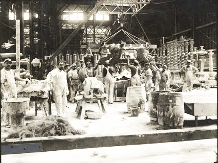 workshop filled with workmen and artwork