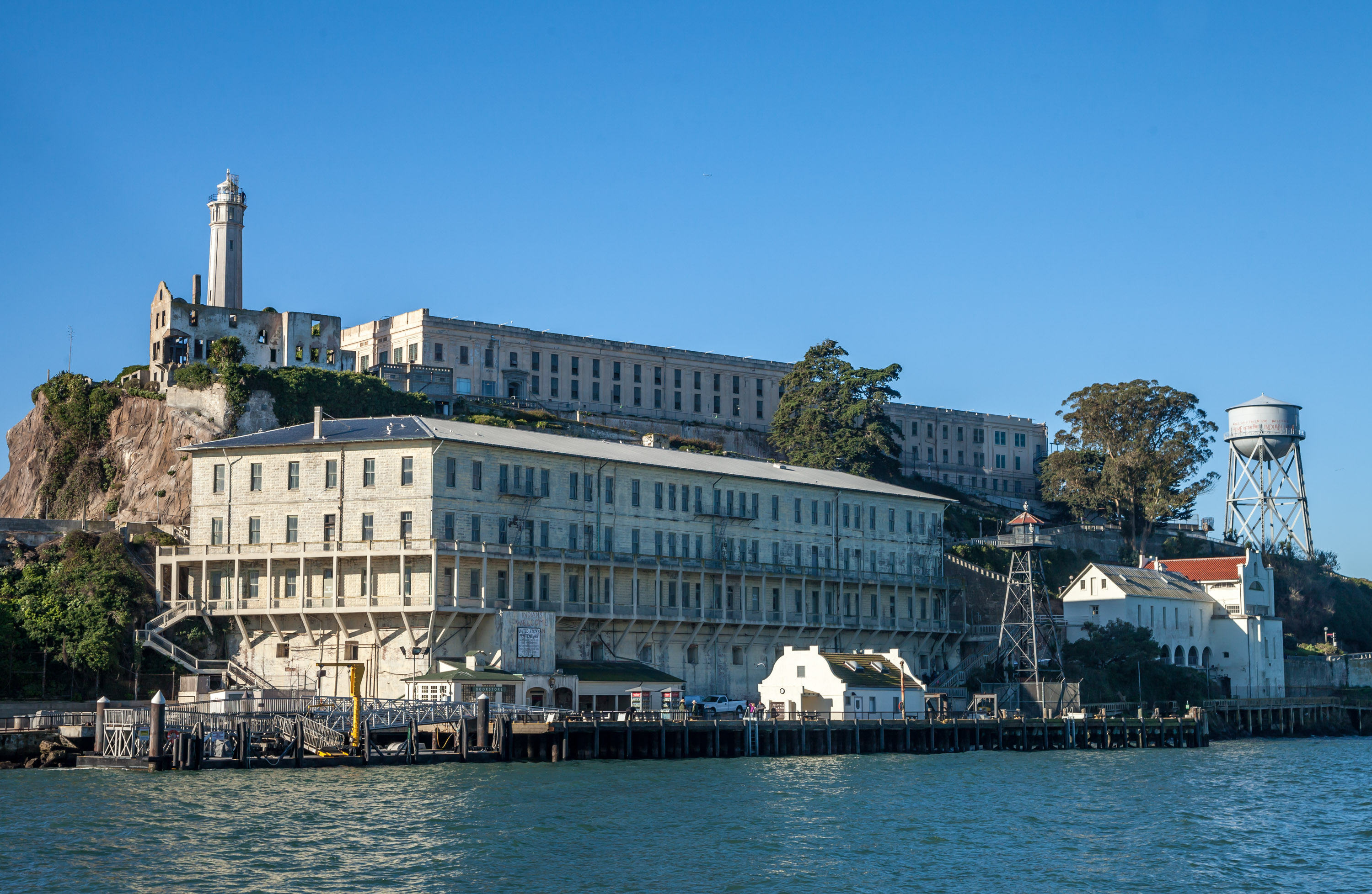 A view of the dock at Alcatraz Island with the cell house and lighthouse in the background