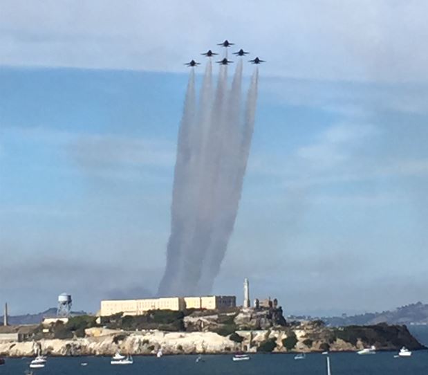 Color photo of six United States Navy's Flight Demonstration Squadron, The Blue Angels, flying in a standard Delta Formation over Alcatraz Island on October 5, 2018. Photo taken from Black Point Battery, Fort Mason, San Francisco. Photo credit NPS/KBeltra